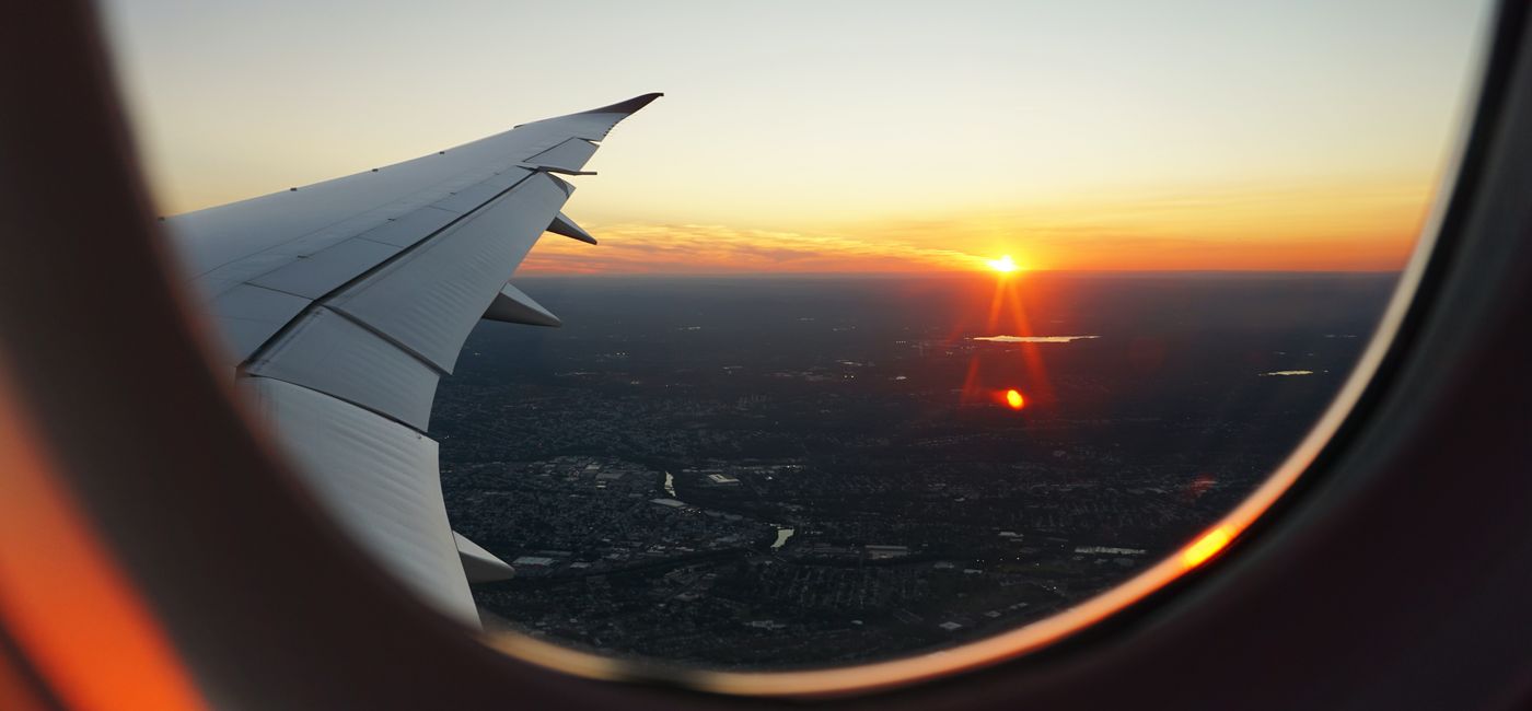 Image: Sunset from plane window. (Photo Credit: Expedia Group)