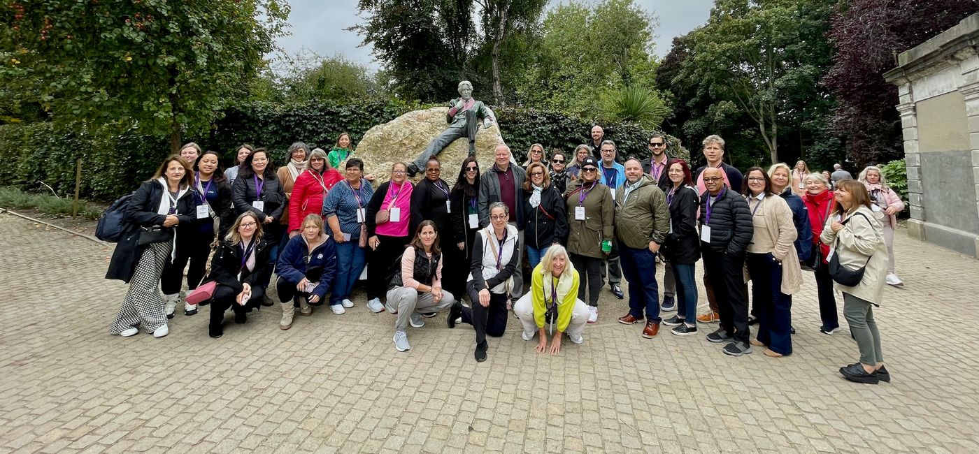 Image: Ready to Go! Participants in the Air Canada-United Race 2024 pose in front of a statue of Oscar Wilde in Dublin. (Photo Credit: Bruce Parkinson)
