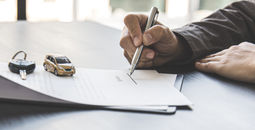 Traveler signing a rental car agreement