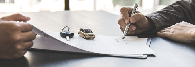 Traveler signing a rental car agreement