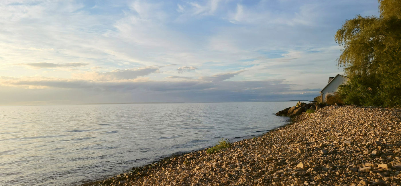 Image: The sun sets over a small beach on Lake Michigan's shoreline at Peninsula Players Theatre in Door County, WI. (Photo Credit: Lacey Pfalz)