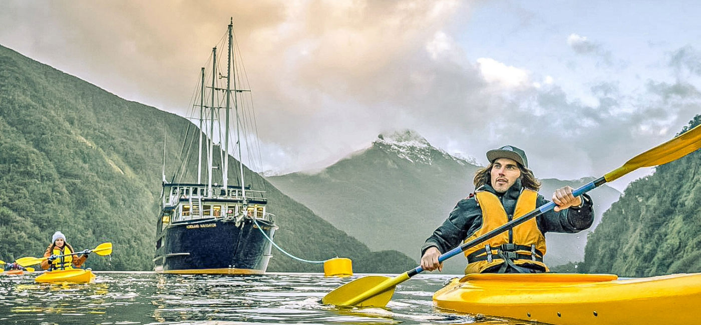 Image: Contiki's Real New Zealand itinerary includes a kayak tour of Doubtful Sound during an overnight cruise. (Photo Credit: Contiki)