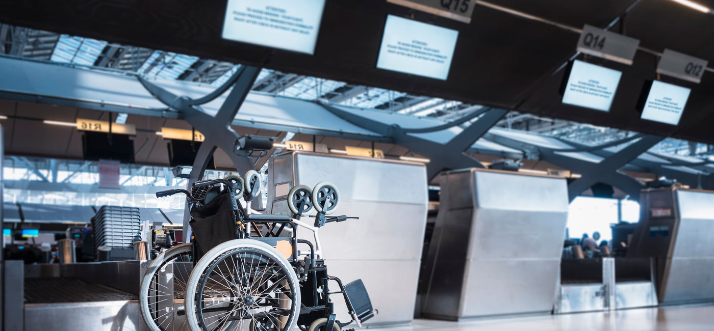 Image: Wheelchair at airline check-in counter. (Photo Credit: VTT Studio / Adobe Stock)