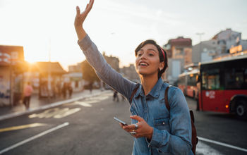 Woman waiving to Uber driver.