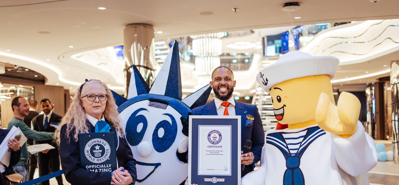 Image: Guinness World Records adjudicator Beverley Williams and MSC World America cruise director Eversen Bevelle celebrate the new world record (Photo Credit: MSC Cruises)