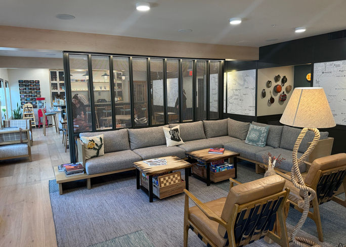 The cozy lobby of Mountain Modern Sedona with The Den restaurant in the background