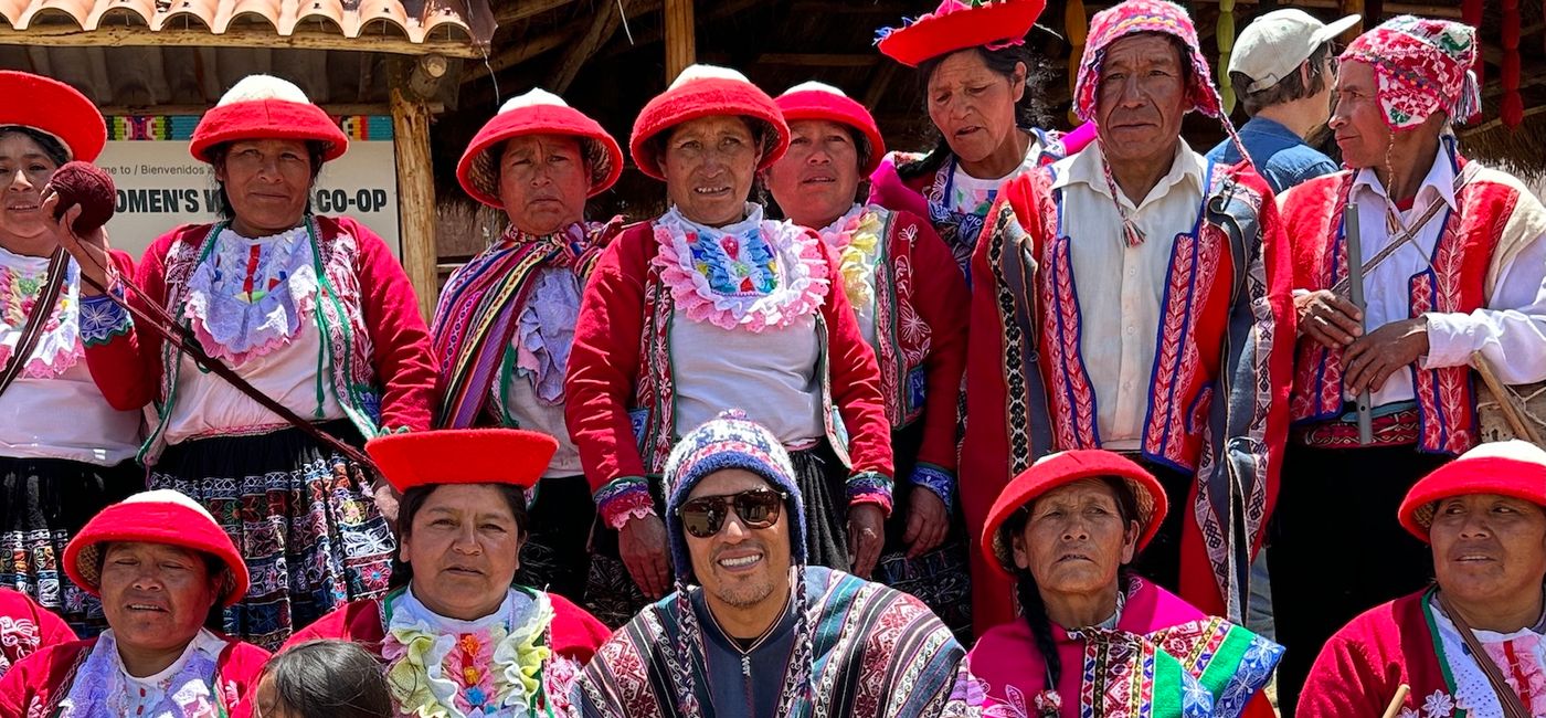 Image: Bruce Poon Tip at a weaving cooperative in Peru. (Photo Credit: G Adventures)