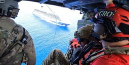 Members of the 920th Rescue Wing approach Carnival Venezia over Atlantic Waters.
