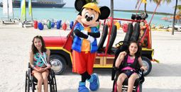 Kara and Ella Betancourt pose with Mickey Mouse at Disney Castaway Cay.
