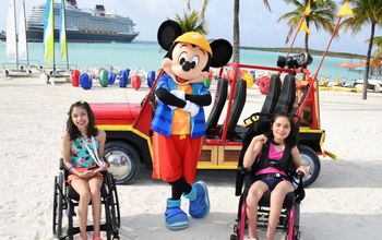 Kara and Ella Betancourt pose with Mickey Mouse at Disney Castaway Cay.