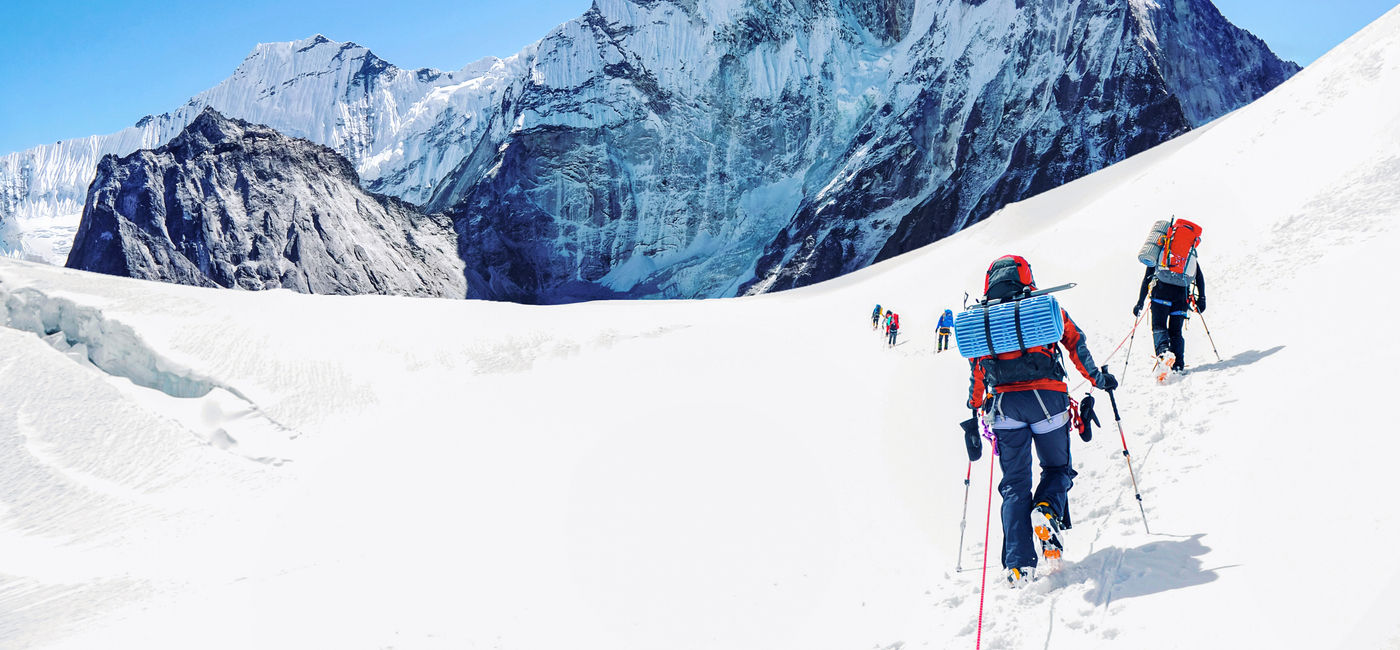 Image: Group of climbers reaching the Everest summit in Nepal. (Photo Credit: Andrii Vergeles)