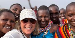 Travellers visit a Maasai village in Kenya during a small-group tour with Collette