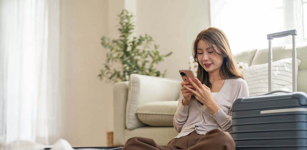 Woman booking travel from her smartphone