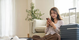Woman booking travel from her smartphone