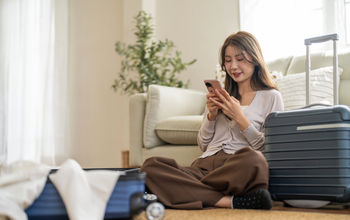 Woman booking travel from her smartphone
