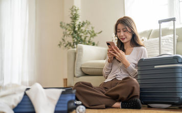 Woman booking travel from her smartphone
