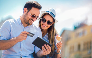 A couple booking travel with a credit card