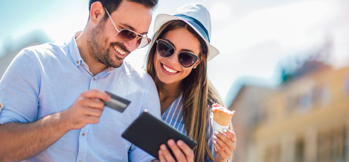 Image: A couple booking travel with a credit card. (Photo Credit: Mediteraneo/Adobe Stock)