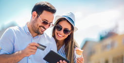 A couple booking travel with a credit card