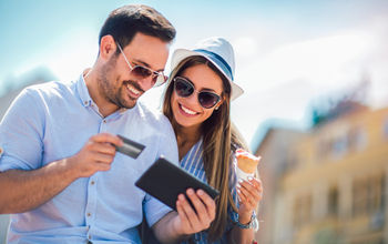 A couple booking travel with a credit card