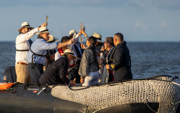 guests in Zodiac rafts at Silver Origin christening