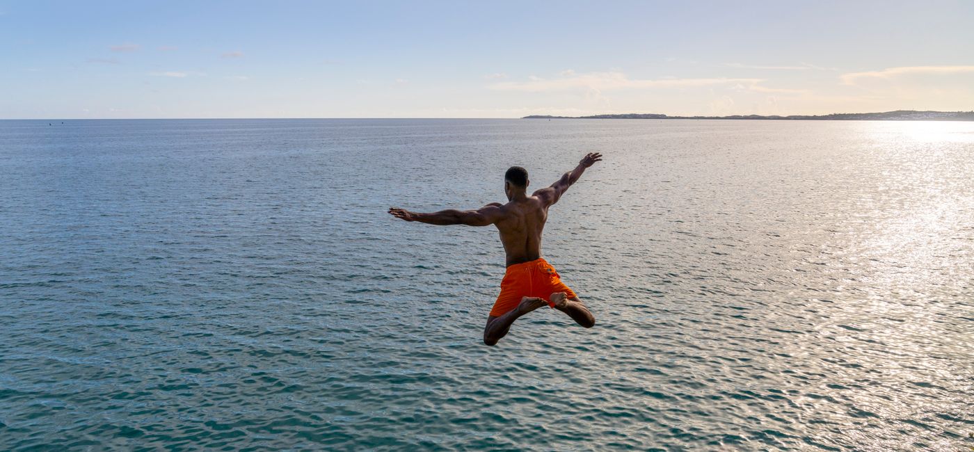 Image: A man jumps off a cliff into the sea in Bermuda. (photo via Bermuda Tourism Authority) ((photo via Bermuda Tourism Authority))
