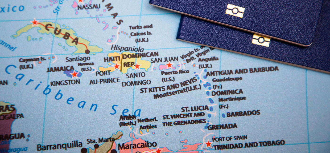 Image: Passports on a map of the Caribbean region. (Photo Credit: Adobe Stock/drotik)