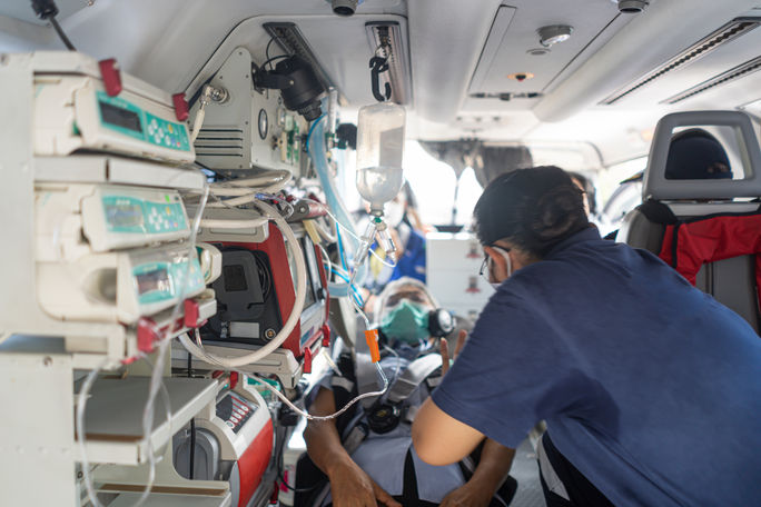 Patient and paramedic inside medical emergency evacuation helicopter. 