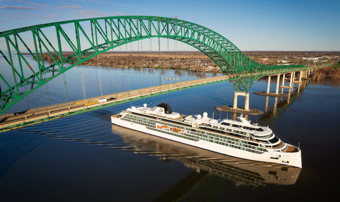 A ship passes under a bridge.