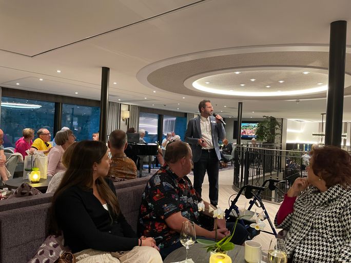 The cruise director offers daily briefings in the lounge 