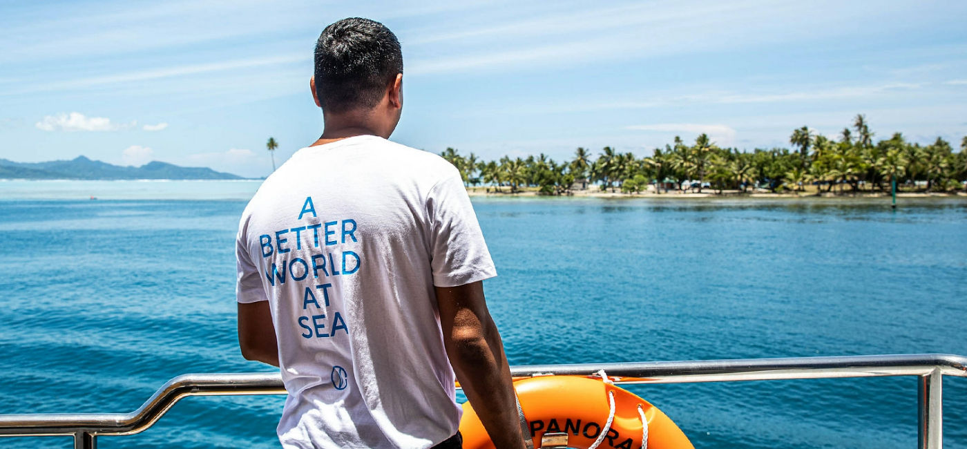 Image: A crew member onboard a Variety Cruises ship gazes out at an island in French Polynesia. (Photo Credit: Variety Cruises)