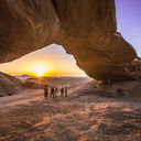Jordan Wadi Rum Desert rock arch underneath sunset