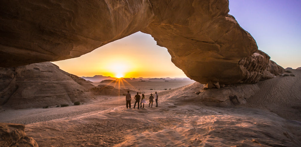 Jordan Wadi Rum Desert rock arch underneath sunset