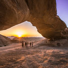 Jordan Wadi Rum Desert rock arch underneath sunset
