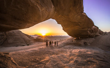 Jordan Wadi Rum Desert rock arch underneath sunset