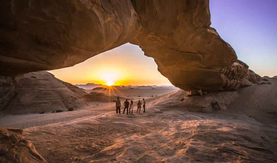 Jordan Wadi Rum Desert rock arch underneath sunset