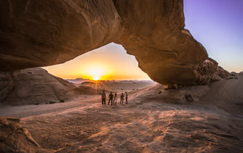 Jordan Wadi Rum Desert rock arch underneath sunset