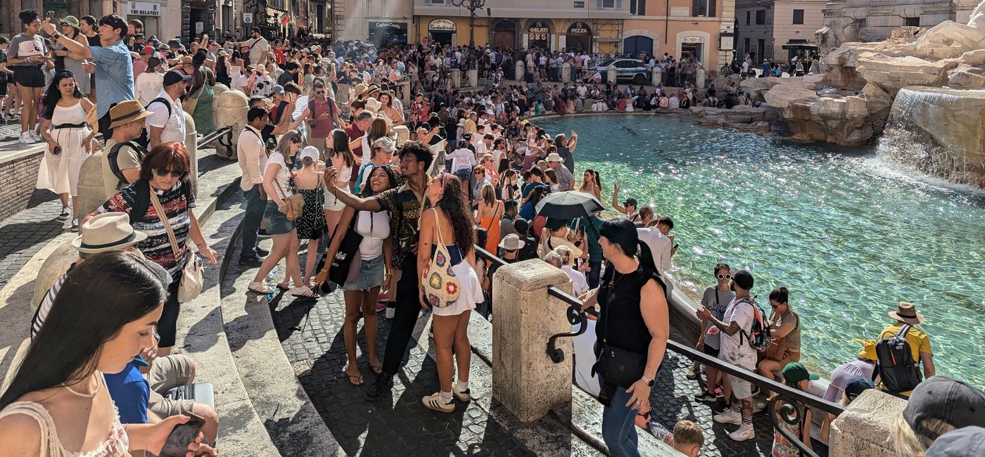 Image: Travelers at the Trevi Fountain in  Rome, Italy (Photo Credit: Eric Bowman)