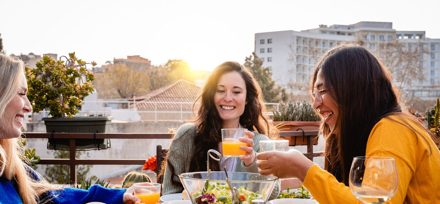 Image: A group of friends eating a meal. (Photo Credit: Courtesy AdobeStock)