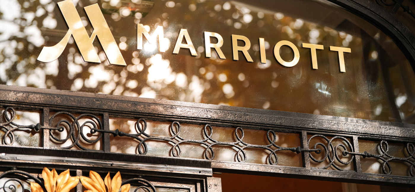 Image: Marriott logo on a hotel facade in Paris, France. (Photo Credit: Adobe Stock/Drago? Asaftei)
