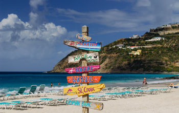 Signpost pointing the way to various Caribbean Islands.