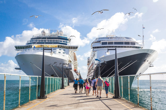 Advisors Are Cautiously Optimistic About the Year Ahead Two cruise ships on either side of dock, cruise ships, stock image of cruise ships