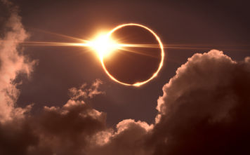Total solar eclipse seen amid the clouds.