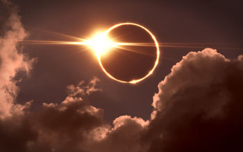 Total solar eclipse seen amid the clouds.