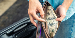 A traveler rifling through their wallet.