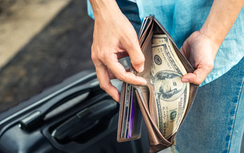 A traveler rifling through their wallet.