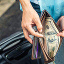 A traveler rifling through their wallet.