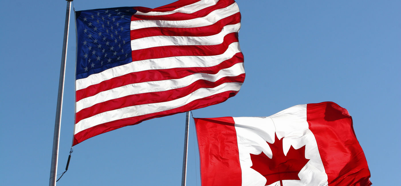 Image: The U.S. and Canadian national flags. (Photo via iStock/Getty Images E+/KKIDD)
