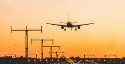Airplane landing at sunset