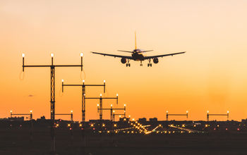 Airplane landing at sunset